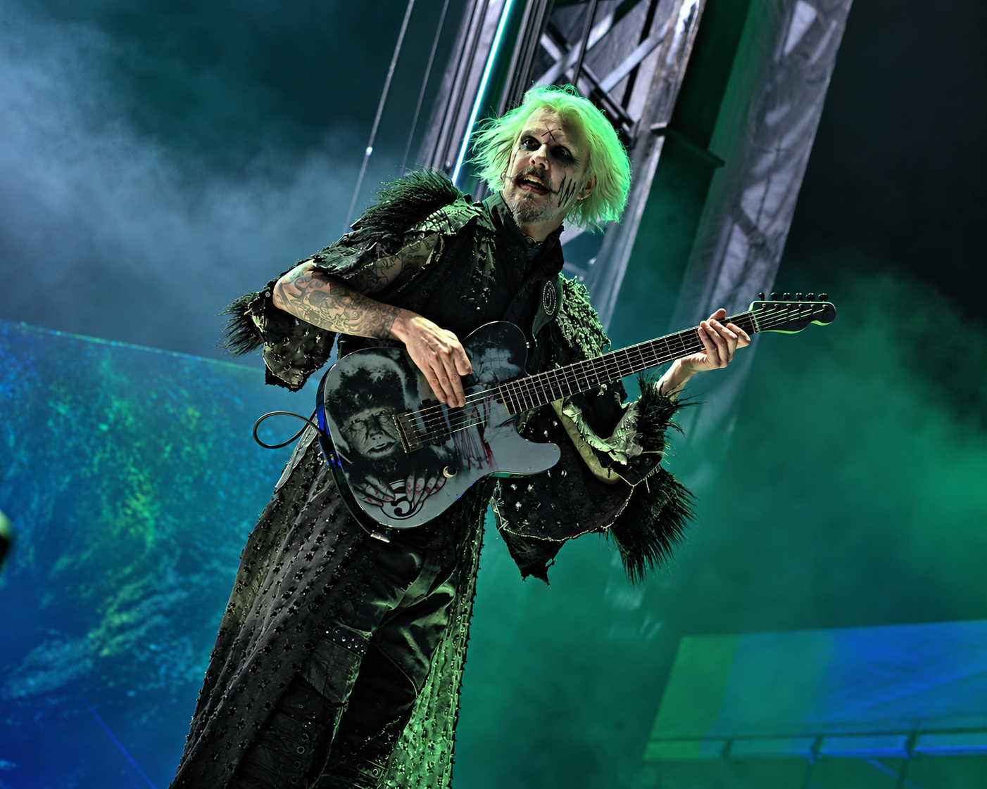 John 5 playing a Telecaster under green stage lighting
